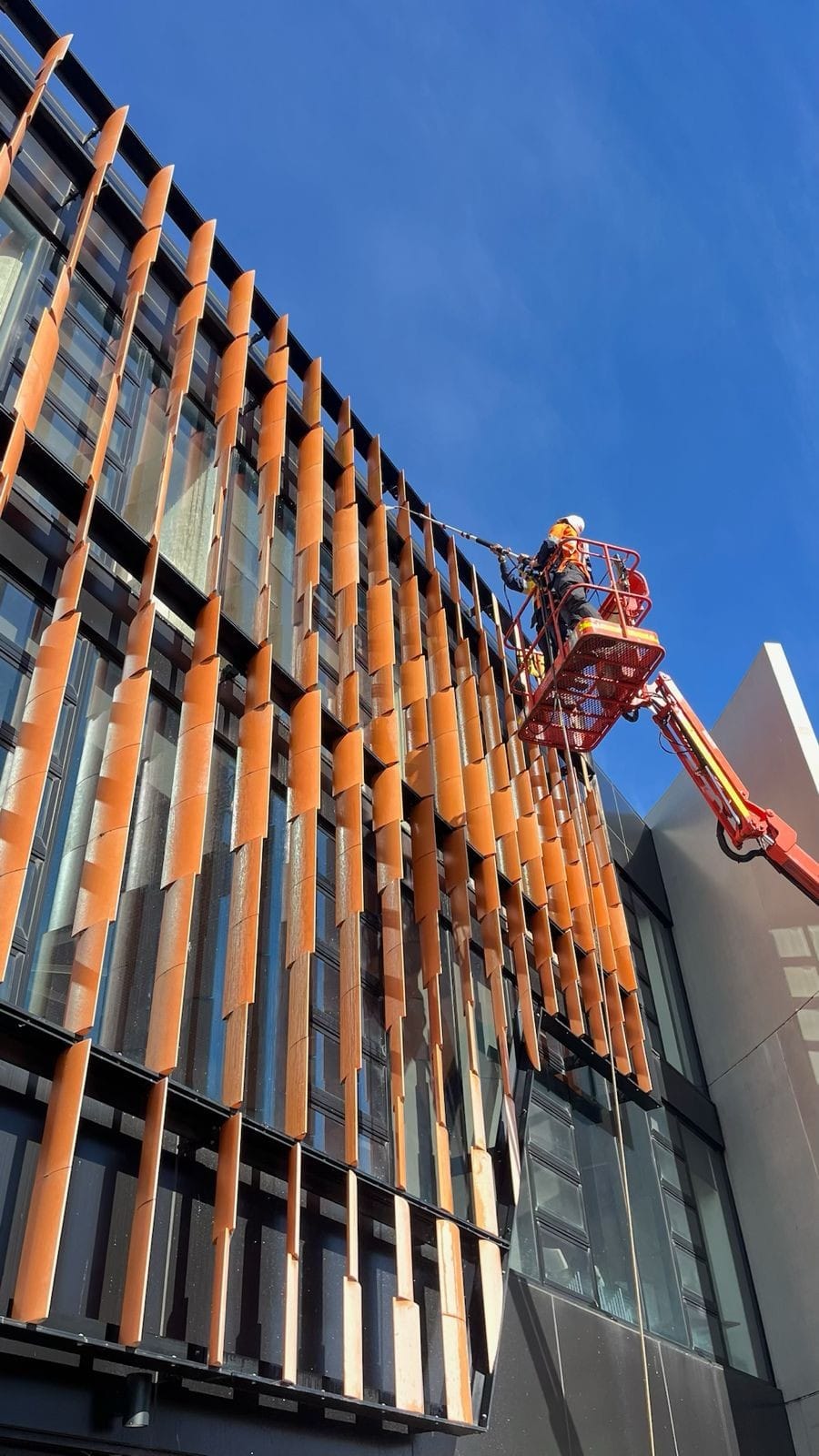 Professional facade cleaning using advanced techniques to remove dirt, stains, and buildup, enhancing the building’s exterior appearance.